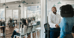 man greeting woman in office